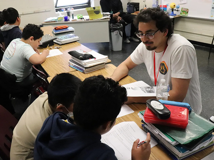 VCU student works with fifth graders on a science activity