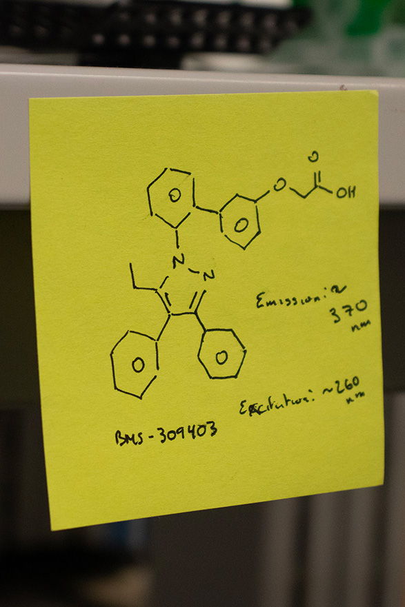 A yellow sticky note with a drawing of a chemical compound